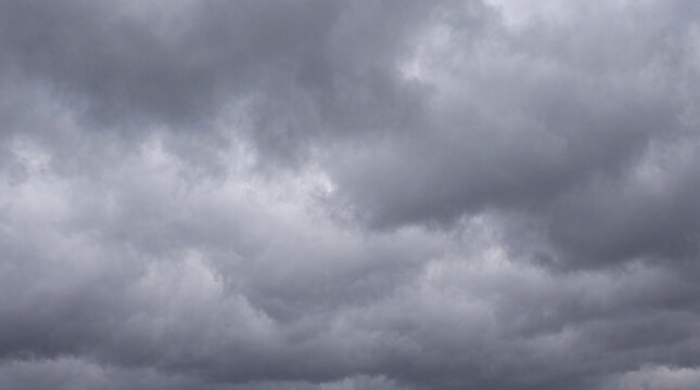 Dense, textured grey storm clouds filling the vast expanse of the sky.