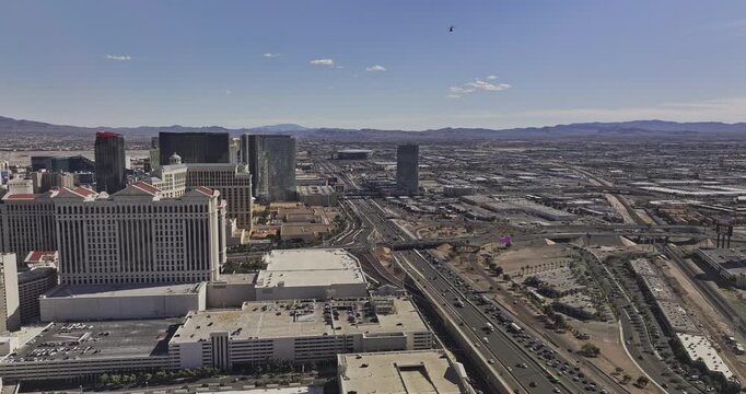 Las Vegas Nevada Aerial v109 flyover above Interstate 15 and freeway interchanges beside Caesars Palace, Strip hotels, suburbs and mountains - Shot with Mavic 3 Pro Cine - Apr 30th 2024