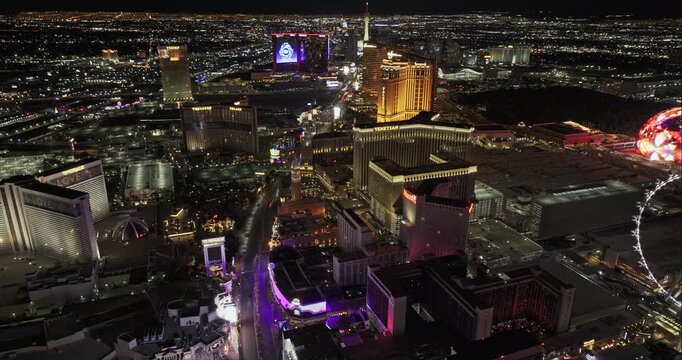 Las Vegas Nevada Aerial v152 reverse bird's-eye night flyover across the High Roller, Flamingo, Caesars Palace and central Strip lights - Shot with Mavic 3 Pro Cine - May 1st 2024