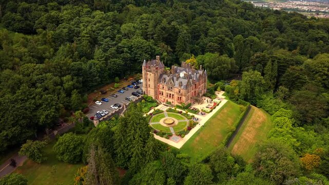 Clockwise 4K 60FPS aerial video of Belfast Castle and Cavehill in North Belfast, Northern Ireland in the UK on a bright sunny day. Produced with Rec709 colour.
