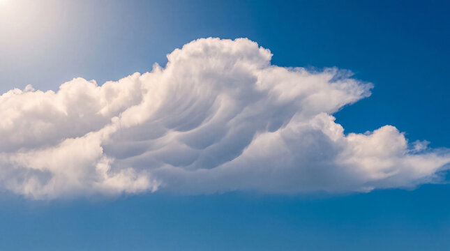 Unique asperitas cloud formation with dramatic textures and a sun flare against a bright blue sky on a clear day.