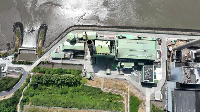 aerial down view Detailed aerial footage of hydroelectric electricity facility beside the River Suir. Modern renewable energy infrastructure set against the picturesque countryside of County Wexford.