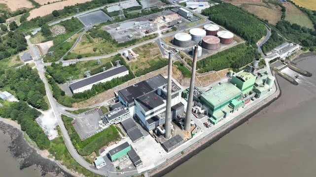 down view cooling towersDrone flyover of hydroelectric power plant on the River Suir, County Wexford. Clean energy technology integrated into Ireland's picturesque river landscape