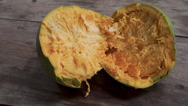 Cut Open Green Bael Fruit on Rustic Table