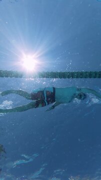 Low Angle View of Man Swimming Front Crawl in Sunny Pool
