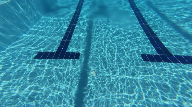 Underwater View of Swimming Pool Floor Markings and Ripples