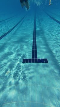 Underwater View of Swimming Pool Lanes with Swimmer Diving in Distance