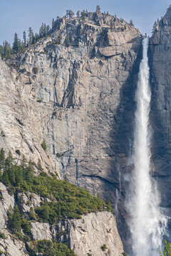 Vertical closeup view of majestic Upper Yosemite Fall and high granite cliffs