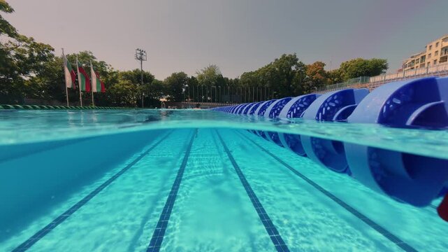 Split View of Swimmer in Outdoor Olympic Swimming Pool