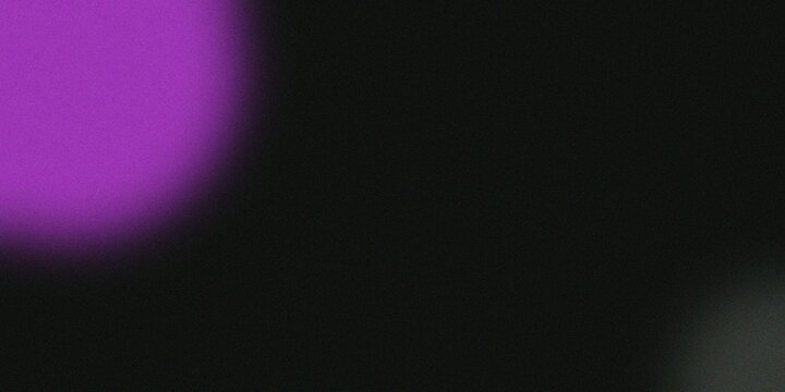 Abstract purple and black background with soft light effects and bokeh.
