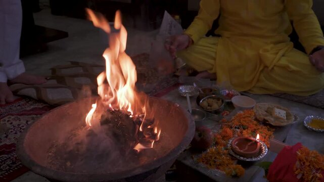 Traditional fire ritual with offerings indoors