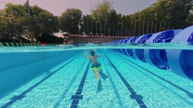 Split View Two Boys Swimming Underwater in Outdoor Pool