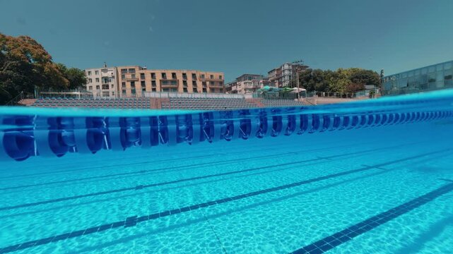 Split View Outdoor Swimming Pool Lanes with Swimmer in Distance
