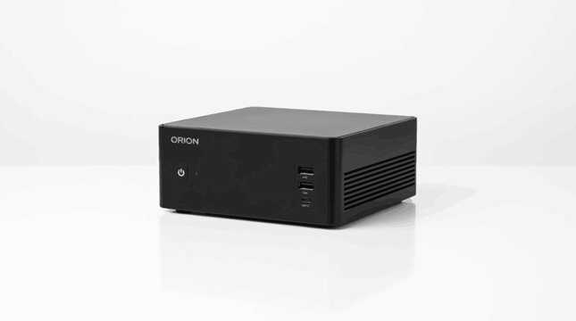 Compact desktop workstation featuring front USB ports rests on a white studio surface.