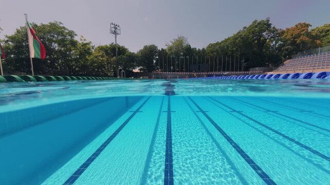 Split View Empty Outdoor Olympic Swimming Pool Lanes