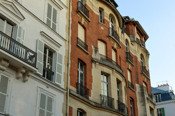 Obraz premium Paris architecture creating a historic cityscape with residential buildings displaying traditional balconies and windows