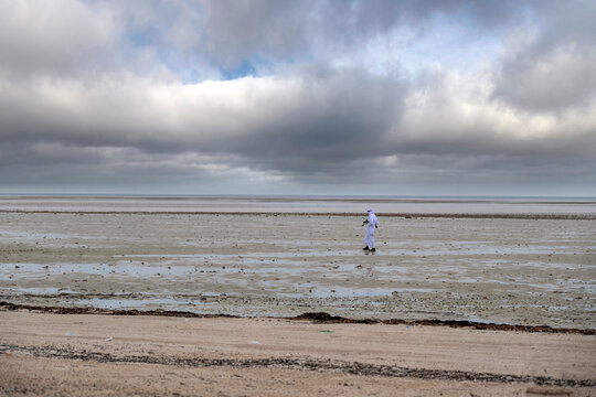 Zikreet, Qatar - January 10, 2026:  Vast tidal shoreline beneath dramatic storm clouds. Wakra Beach Qatar