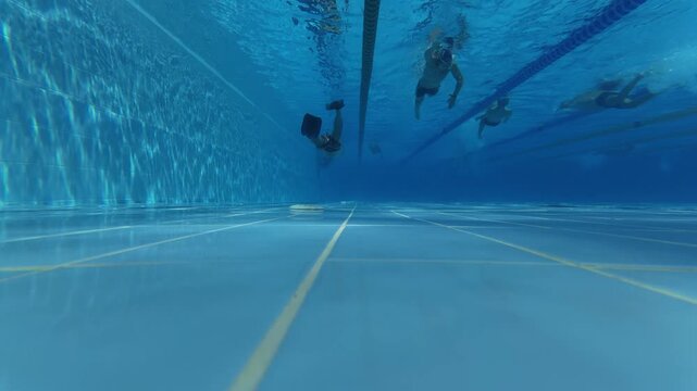 Underwater View of Swimmer in Flippers Swimming in Pool