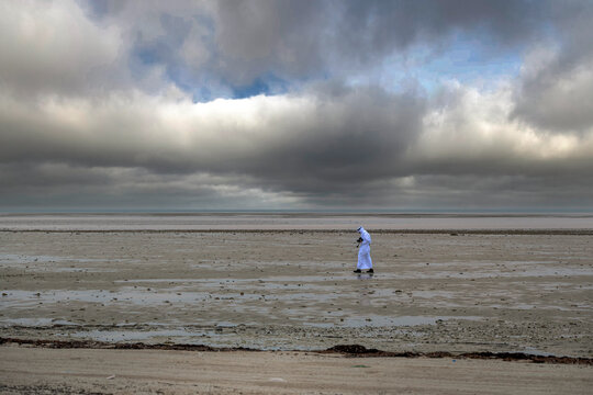 Zikreet, Qatar - January 10, 2026:  Vast tidal shoreline beneath dramatic storm clouds. Wakra Beach Qatar