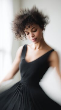 Female dancer spinning in studio, motion blur, flowing black dress. Abstract human form expressing energy, artistic composition