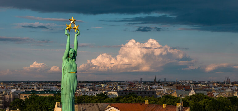 Aerial view of The Freedom Monument rising above the historic rooftops and city skyline of Riga, Latvia.
