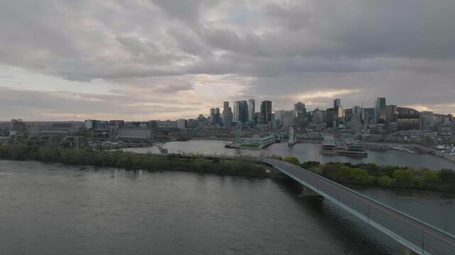 drone flying next to main bridge from park jean drapeau overlooking the old port n the city of montreal quebec canada