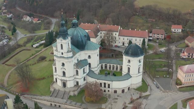 drone flying over main church called virgen marie in a small town krtiny near brno in czech republic also the old castle of the city