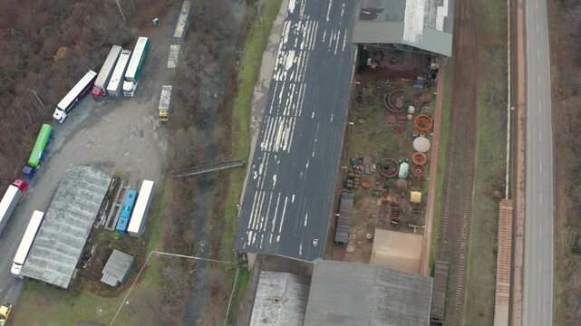 drone overlooking an abandon factory overlooking some riuns n train tracks from top botton around a river