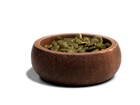 Wooden bowl of pumpkin seeds isolated on transparent background, healthy snack cutout