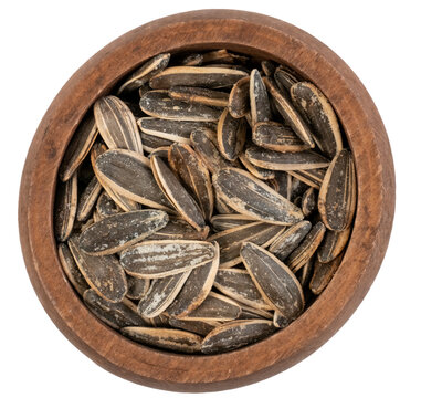 Top view wooden bowl of striped sunflower seeds isolated on transparent background
