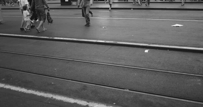People walking at tram station in the city - Urban lifestyle concept - Black and white editing