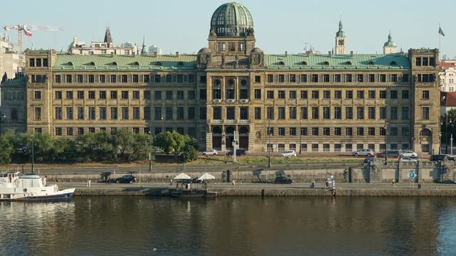 The Ministry of Industry and Trade building stands along the Vltava embankment in Prague. Monumental architecture represents state government, public administration, and national economy.