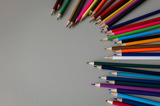 Colorful Pencils Form a Curved Frame Around Generous Copy Space
