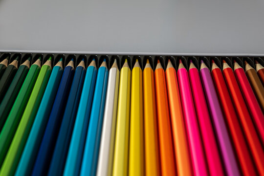 Rainbow Colored Pencils in Boxed Row Beneath Wide Copy Space