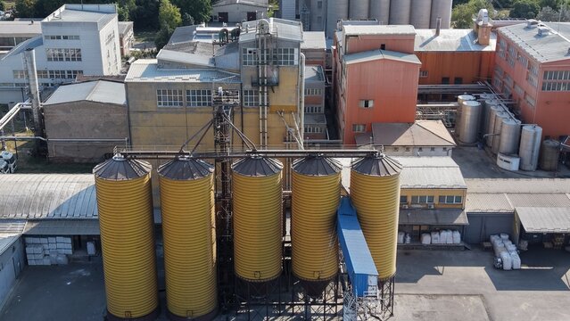 Aerial view of the industrial facility with yellow grain silos and storage tanks in the Severna zona industrial area in Pancevo, Serbia.