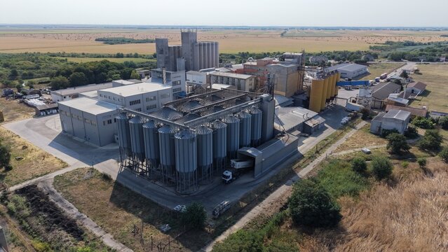 Aerial view of the Severna zona industrial facility in Pancevo, featuring large metal grain silos, processing buildings, and a truck at the loading area in Pancevo, Serbia.