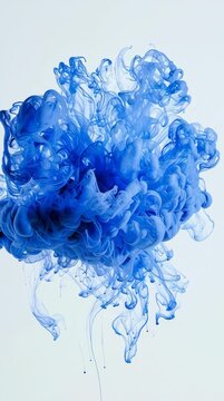 An ink drop in vivid blue enters clear water and blooms, creating an intricate display of shapes and colors in real time.