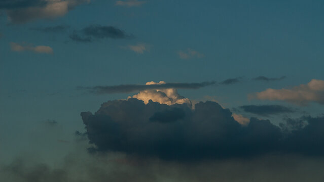 White Cloud Against Blue Sky and Dark Storm Cloud in Spring for Web Banner.
