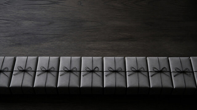 A long panoramic row of identically wrapped plain grey parcels lined