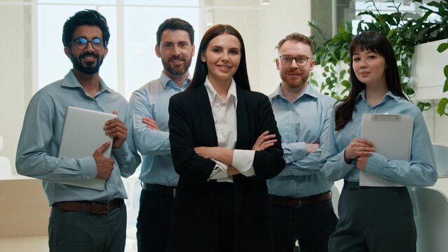 Happy multiethnic business team posing with crossed arms looking at camera indoor office smiling men women female leader confident colleagues employees diverse coworkers corporate success leadership