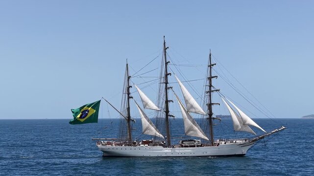 Aerial view of a three-masted sailing ship with sails sailing in the Atlantic Ocean. 