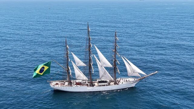 Aerial view of a three-masted sailing ship with sails sailing in the Atlantic Ocean. 