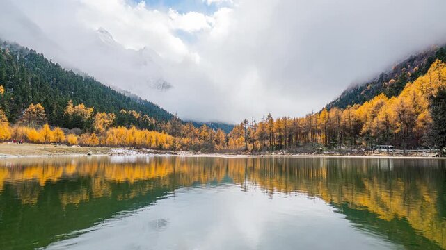 Timelapse of Bipenggou national park with snow mountains in autumn, Sichuan in China.