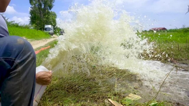 Water pumping into grass field