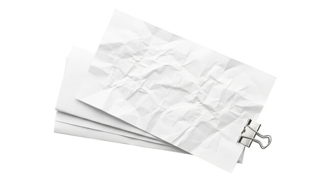 Stack of crumpled white paper sheets held together by a binder clip.