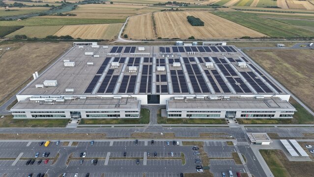 Aerial view of the ZF factory in the Severna zona industrial park with solar panels on the roof and a large parking lot in Pancevo, Serbia.