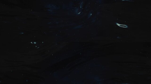Black fluid surface rippling with subtle waves and tiny stars. Minimalist dark matter background for premium use.