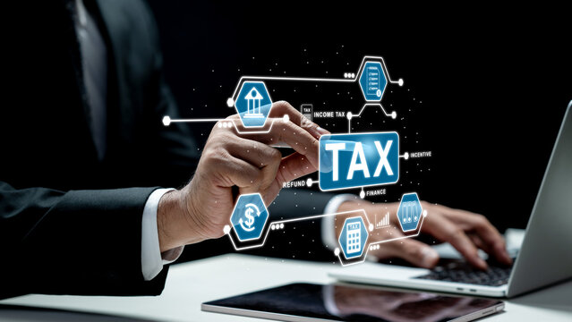 Businessman using a laptop and tablet while interacting with a futuristic digital tax interface. Concept of a Tax Consultant