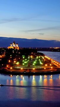 Vertical video. Yaroslavl, Russia. Strelka (Spit), Kotorosl flows into the Volga River. City lights after sunset, twilight. Drone footage. Rich colors