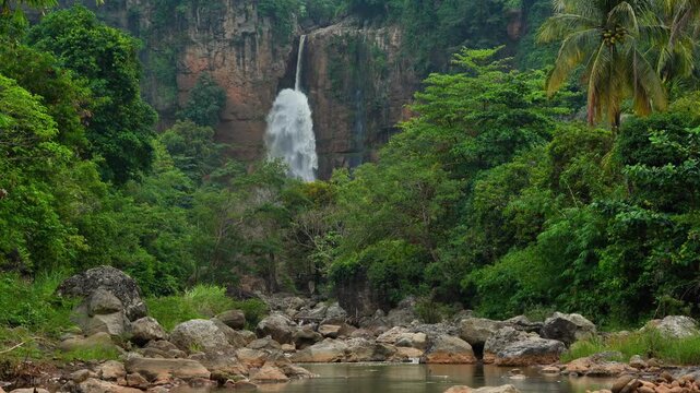 Curug Cimarinjung waterfall flowing through rocky canyon in Ciletuh Geopark Sukabumi Indonesia
